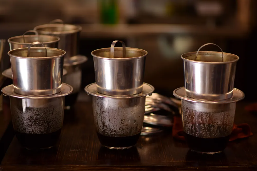 Three Vietnamese phin coffee filters brewing in Convoy District San Diego